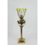 Brass Corinthian column pedestal oil lamp, lime green tinted and floral etched shade over a