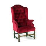 William and Mary style upholstered wing armchair, upholstered in deep buttoned red fabric, raised on