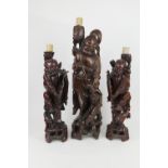 Pair of Chinese carved wooden figural lamp bases, worked as fishermen, 20th Century, height 60cm;