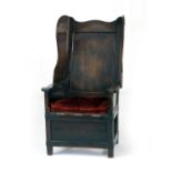 Provincial oak 'lambing' chair, 19th Century, recessed panel back with solid wings, cushioned and