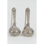 Pair of Persian silver scent flasks, circa 1900, baluster form with slender necks, domed cover and a