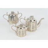 Indian white metal three piece tea service, circa 1900, comprising lidded teapot, with elephant
