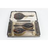 George V silver and pique tortoiseshell vanity set, Birmingham 1919, comprising hand mirror, two