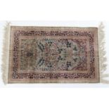Isfahan silk prayer rug, the mihrab dispersed with flowerheads and a vase, with red spandrels,