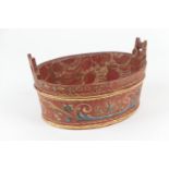 Scandinavian traditional painted wooden bowl, decorated with foliate scrolls against a red ground,