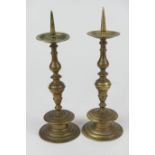 Pair of Dutch style bell metal pricket candlesticks, height 27.5cm (NB: Condition is NOT noted in