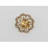 15ct gold peridot and seed pearl brooch, the round cut peridot of approx. 4cts, bordered in a