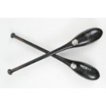 Pair of Victorian ebonised wooden exercise batons by Arlington Slaters of Liverpool, each with a