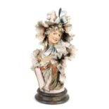 Royal Dux bust of a Belle Epoque young lady in elaborately frilled costume, decorated in coloured