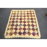 Patchwork quilt, circa 1930s/40s, worked with chevron banded squares within a crocheted border,