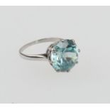 Blue zircon solitaire dress ring, the round cut stone of approx. 5cts, claw mounted in unmarked