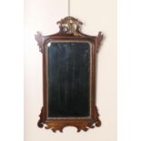 Mahogany and parcel gilt fretwork mirror, in the Georgian style, surmounted with a ho-ho bird and