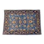 Tabriz sky blue ground rug, the field with fawn palmettes within an indigo blue border, size approx.