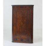 Provincial oak and inlaid flat front hanging corner cupboard, early 19th Century, having a