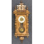 Victorian walnut Vienna wall clock, white dial with Roman numerals, striking on a gong, gridiron