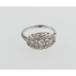 Diamond cluster ring, centred with a round cut diamond of approx. 0.2ct, bordered with smaller,