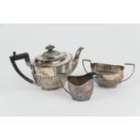 Composite silver three piece tea service, comprising a Victorian silver presentation teapot,
