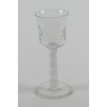 George III opaque twist wine glass, circa 1770, bucket bowl engraved with fighting cocks, over a
