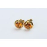 Pair of citrine ear studs, the circular cut stones mounted in unmarked yellow gold, the heads 9mm