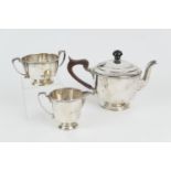 George VI silver three piece tea service, London 1937, plain form, the teapot with replaced ebonised