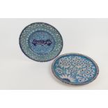 Persian faience plate, centred with calligraphy against a turquoise ground dispersed with