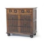 Quality reproduction oak chest of drawers in Tudor Gothic style, having two roundel carved fronted