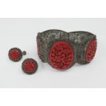Chinese cinnabar lacquer white metal filigree bracelet, mid 20th Century, set with three cameo