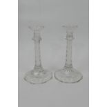 Pair of Regency style cut glass candlesticks, with multi-faceted column over a shaped circular base,