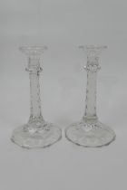 Pair of Regency style cut glass candlesticks, with multi-faceted column over a shaped circular base,