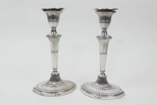 Pair of Edwardian silver candlesticks, in the Adam style, Sheffield 1909, fluted oval section over a