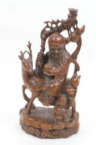Chinese carved wooden figure of Shoulao riding on a deer, early 20th Century, height 34cm (Please