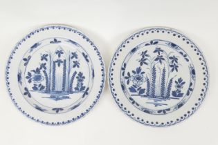 Pair of delft blue and white plates, circa 1740-80, decorated with a formal design of flowers and