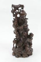 Chinese carved hardwood figure of Shoulao, late 19th/early 20th Century, inlaid throughout with