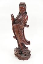 Chinese carved wooden figure of Guanyin, the deity carved standing on a lily pad and water dragon,