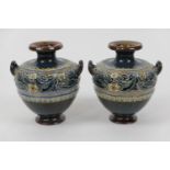 Pair of Doulton Lambeth stoneware small vases, of squat amphora shape with twin handles and