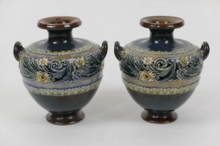 Pair of Doulton Lambeth stoneware small vases, of squat amphora shape with twin handles and