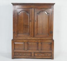 Oak joined livery cupboard, early 18th Century, having a cavetto moulded cornice over two arched