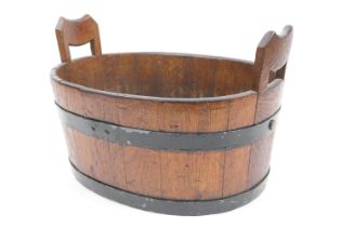 Mahogany and metal coopered oval tub, oval form with integral handles, width 43cm (Please note