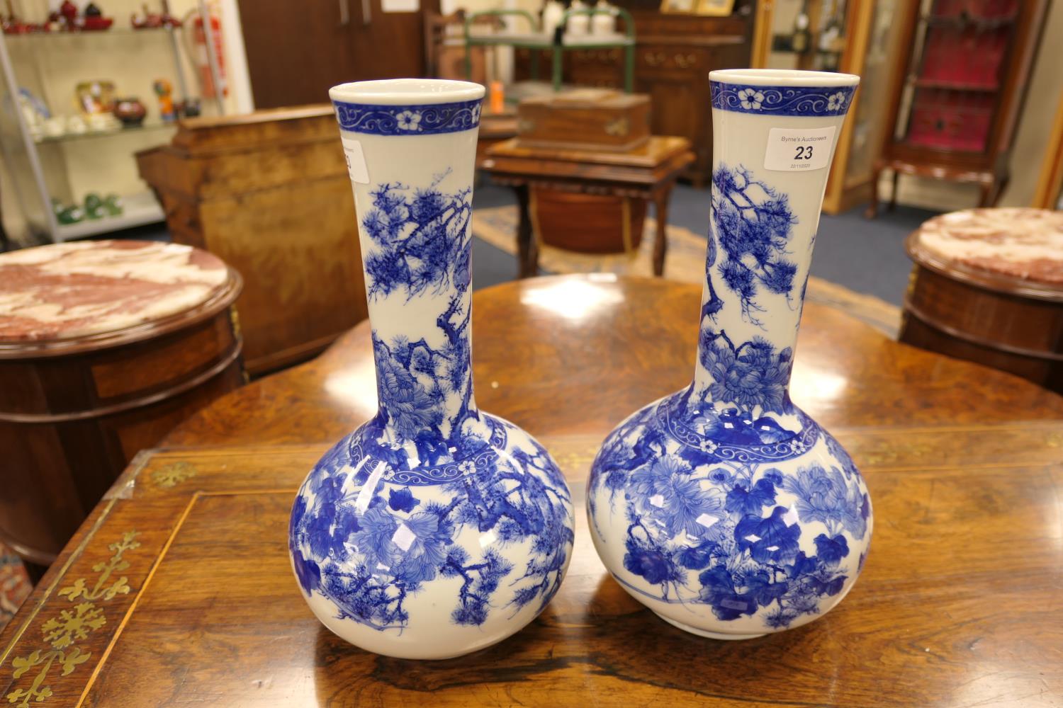 Pair of Japanese blue and white bottle vases, Taisho (1912-26), decorated with peony, fir and - Image 2 of 6
