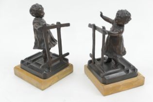 Pair of late Victorian bronzed spelter bookends, circa 1900, cast as children playing blind man's