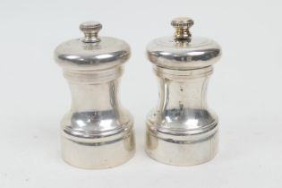 Two modern silver pepper mills, Birmingham 2000, height 8cm (Please note condition is not noted.