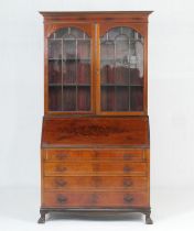 Edwardian mahogany and inlaid bureau bookcase, having two astragal glazed doors opening to three