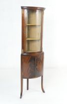 Mahogany bow front corner display cabinet, in the French taste, having a single glazed door