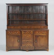 George III oak dresser and plate rack, circa 1760-80, the boarded rack with dentil cornice and two