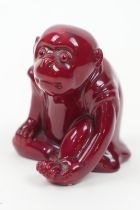 Bernard Moore red flambe monkey figure, with original glass eyes, marked with initials 'BM',
