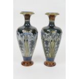 Pair of Doulton Lambeth stoneware vases, ovoid form with trumpet neck, relief moulded with wild