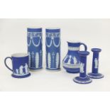 Small selection of Wedgwood dark blue jasper wares comprising two cylinder vases, 25cm and 24.5cm; a