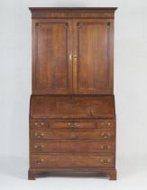 Late George III oak bureau bookcase, circa 1800-20, dentil moulded cornice over two moulded panel