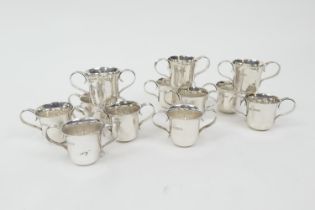 Two sets of six Edwardian silver miniature porringers, London 1904 and 1907, plain form with