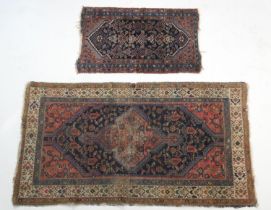 Hamadan woollen rug, with a central red pole medallion against a blue field with red spandrels and a